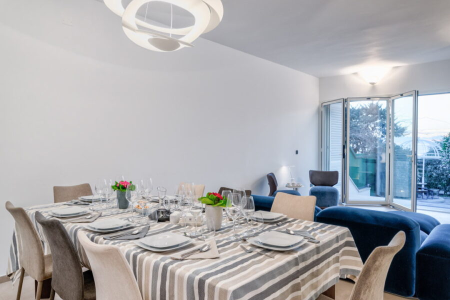 Dining table in the living room on the first floor overlooking the garden with its glass window